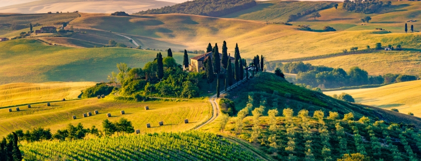 Val d'Orcia, Tuscany, Italy. A lonely farmhouse with cypress and olive trees, rolling hills.