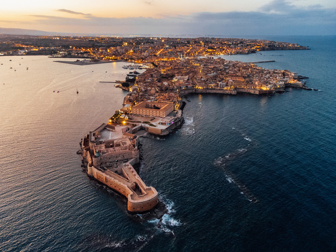 Aerial view of Ortigia Island and Siracusa city at sunset. Landmark in Sicily, Italy.
