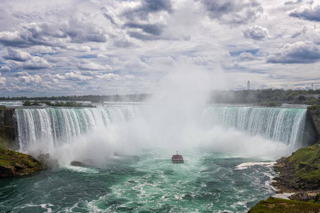 Niagara Falls, Canada - August 14, 2022: People having fun on a tourboat at the Niagara Falls in Canada