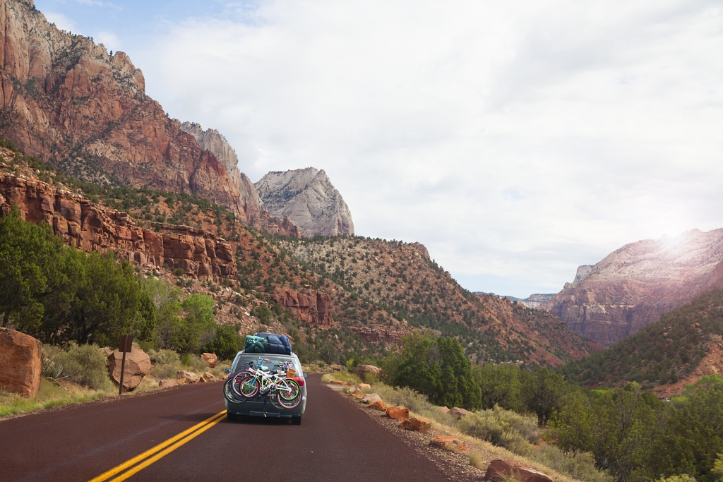 Car on the road with bicycles, touring Utah, USA