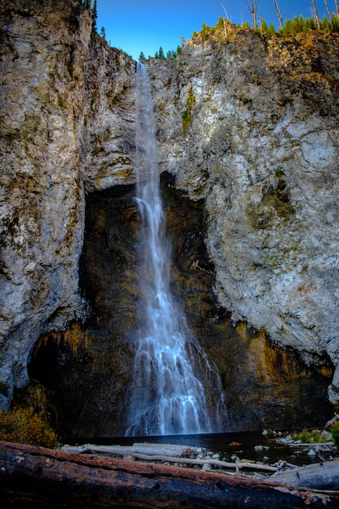The cascading water bouncing off of the cave-like rocks create a beautiful pattern as the water flows into the basin and runs down to the Firehole River.
