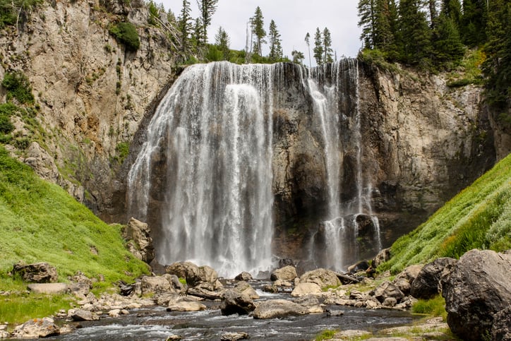 The popular hiking destination of Dunanda Falls, site of a hot spring at the base of the fall, deep inside Yellowstone National Park.