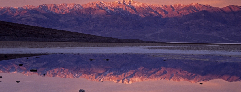 Sunrise colours on Telescope peak reflected in pond at Badwater