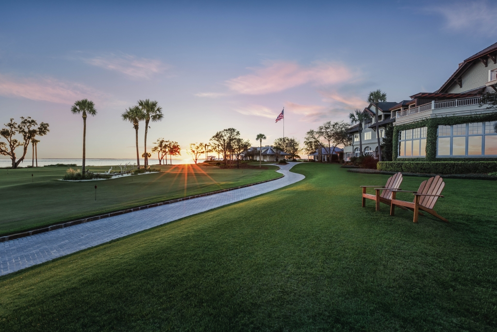 Two chairs on a beautiful lawn at sunset