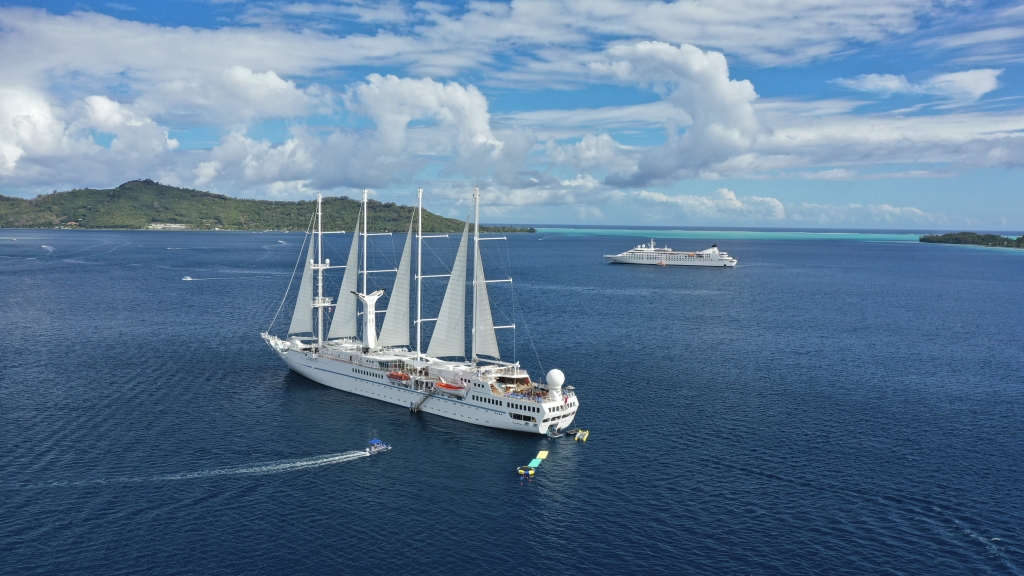 Twi cruise ships anchored on a beautiful day.