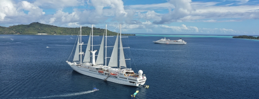 Twi cruise ships anchored on a beautiful day.