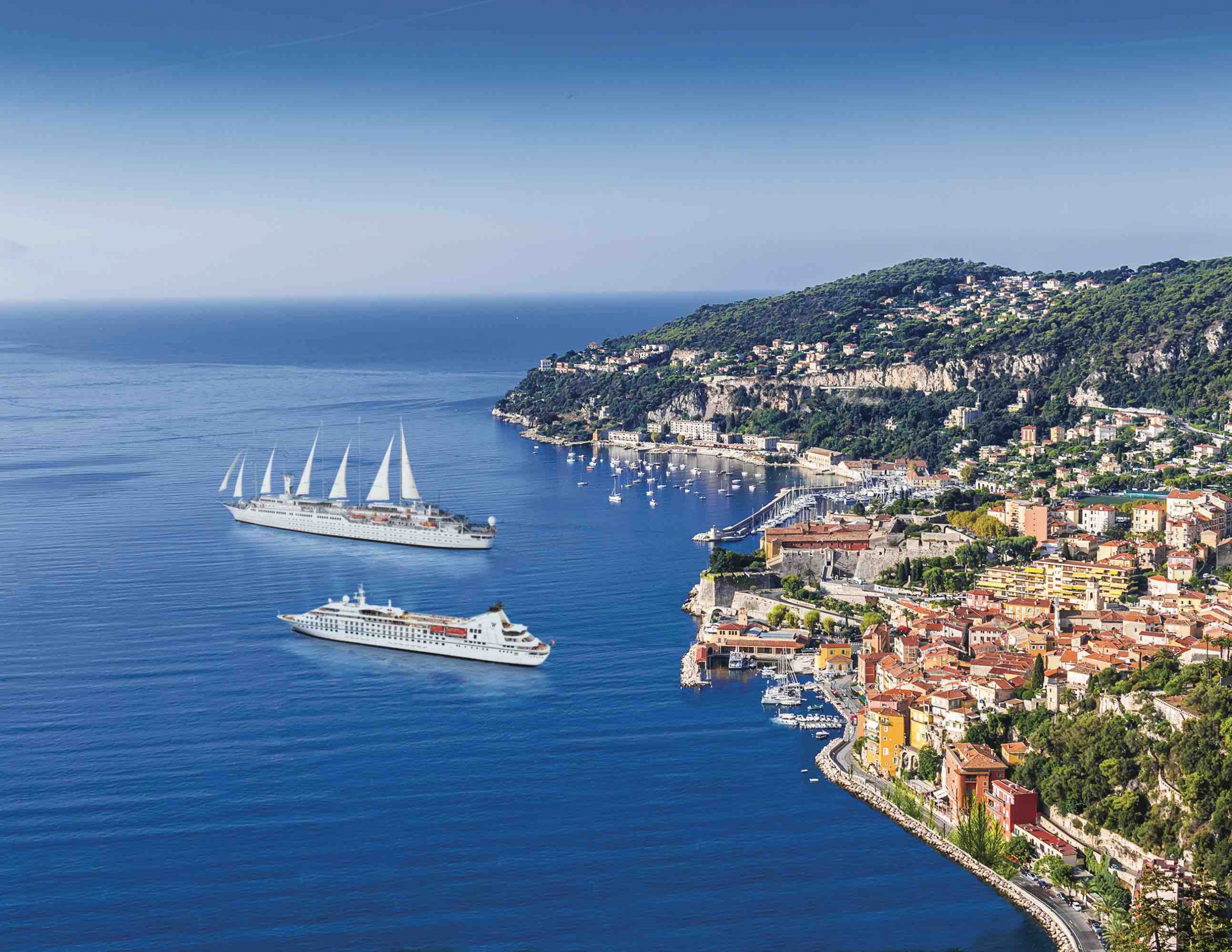 Two cruise ships off a colorful coast