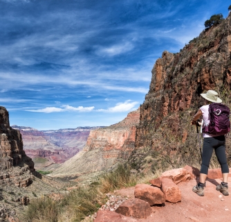 mature female hiker enjoying the view on the soutern rim of the Grand Canyon