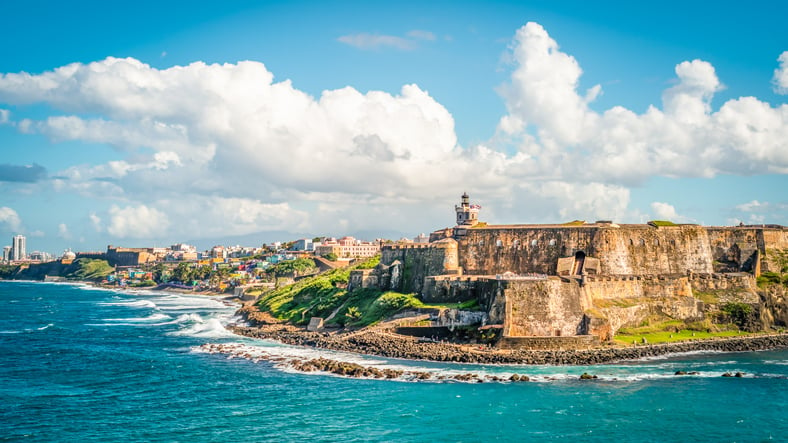 Under ThColorful image with fortification Castillo San Felipe del Morro along the coastline in San Juan, Puerto Rico. Blue sky and white clouds.e Sea 4