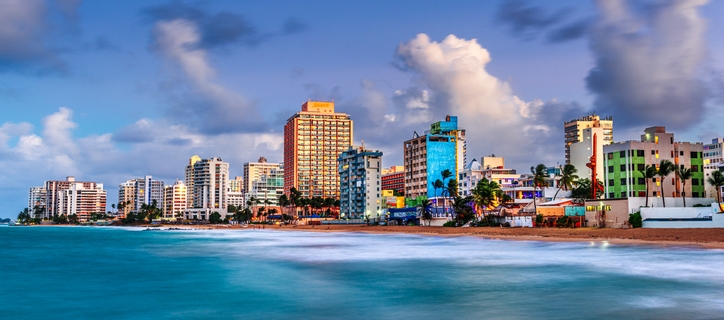 San Juan, Puerto Rico resort skyline on Condado Beach on dusk.