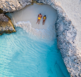 Tres Trapi Steps Triple Steps Beach, Aruba completely empty, Popular beach among locals and tourists, crystal clear ocean Aruba. Caribbean, couple man and woman in a crystal clear ocean